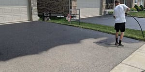 Home Service Solutions sealing an asphalt driveway