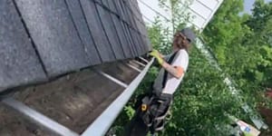 A professional gutter cleaner preparing gutters for the winter
